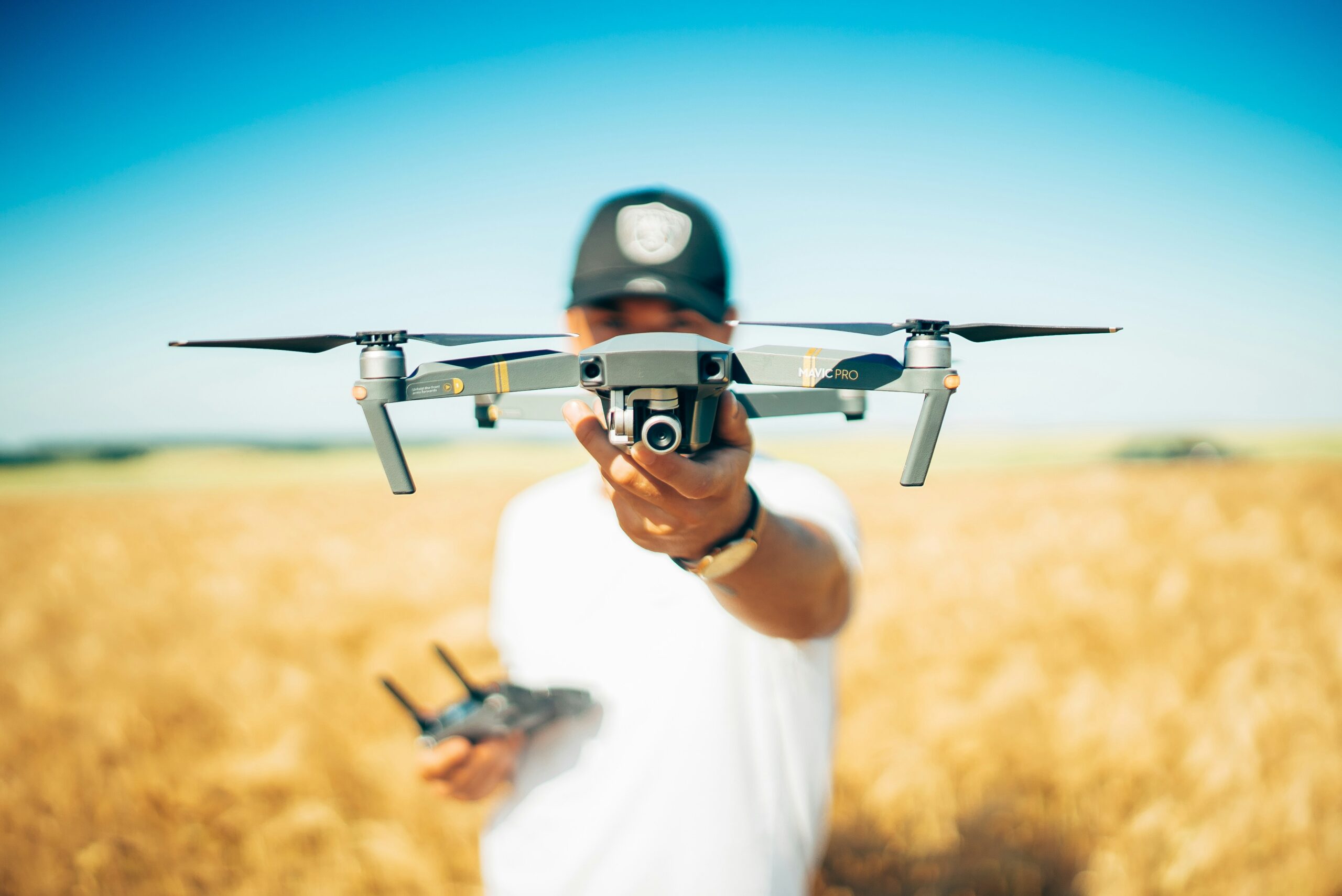 Beginner drone pilot holding a camera drone outdoors while learning safe drone flying and basic piloting techniques.